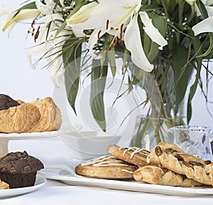 Continental breakfast table setting with pastries and cakes