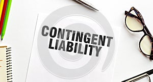 CONTINGENT LIABILITY on paper with glasses and pen photo