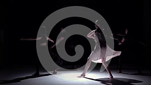 Continue contemporary dance of five dancers on black, shadow, slow motion