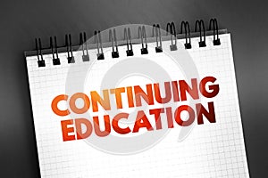 Continuing Education - term within a broad list of post-secondary learning activities and programs, text on notepad, concept