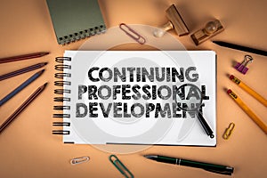 Continuing Professional Development Concept Displayed On Notebook With Office Tools