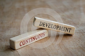 Continuous development text on wooden blocks. Development concept