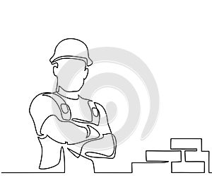 Standing builder man holding tablet photo