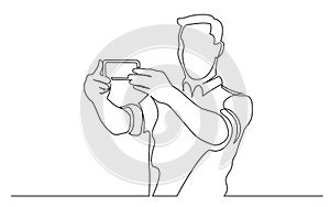 Continuous line drawing of standing man making selfie with his mobile phone