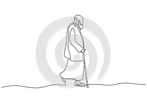 Continuous one line drawing of arabic man walking on the street. Old person wearing thawb or Kandoora, Dishdasha, Khamiis , and photo