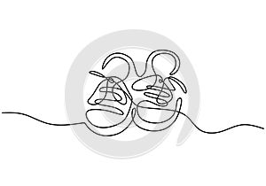 Continuous one line of a pair of baby shoes isolated on white background. For children or kids theme