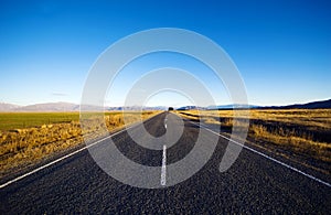 Continuous Road In A Scenic With Mountain Ranges Afar