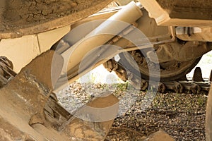 Continuous tracks of construction caterpillar, bulldozer steel metal wheels close up