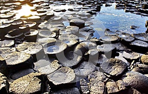The continuous trickle of water over the hexagonal Basalt slabs of Giants Causeway