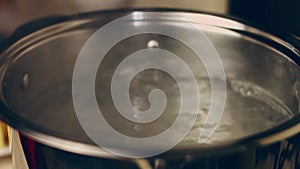 Contour effect of Boiled potatoes in boiling water in a saucepan on a gas stove. Selective focus. 4k video recording