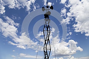 Contour small military radar station on background beautiful clouds and sky. Mobile relay station, Russia