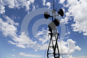 Contour small military radar station on background beautiful clouds and sky. Mobile relay station, Russia