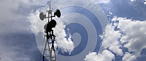 Contour small military radar station on background beautiful clouds and sky. Mobile relay station, Russia