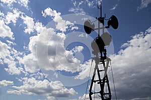 Contour small military radar station on background beautiful clouds and sky. Mobile relay station, Russia