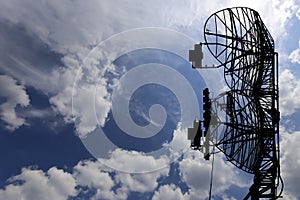 Contour small military radar station on background beautiful clouds and sky. Mobile relay station, Russia