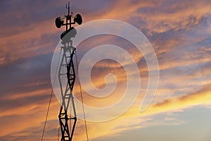 Contour small military radar station on the background of the sunset orange sky. Mobile relay station, Russia