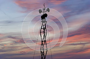 Contour small military radar station on the background of the sunset orange sky. Mobile relay station, Russia