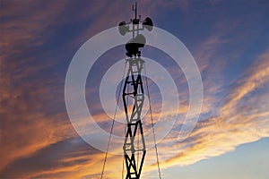 Contour small military radar station on the background of the sunset orange sky. Mobile relay station, Russia