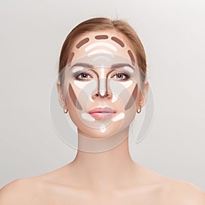 Contouring. Make up woman face on grey background. Professional