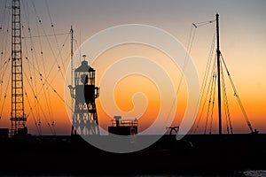 Contours of a lightship along the quay during the sunset