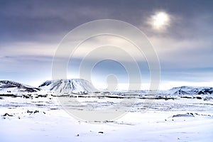 Contra jour snow covered mountain wilderness, north east Iceland in winter photo
