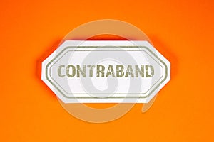 Contraband. Sticky note with text on an orange background photo