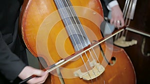 Contrabass fiddlestick strings play. Close-up