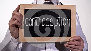 Contraception written on blackboard in therapist hands, HIV AIDS prevention