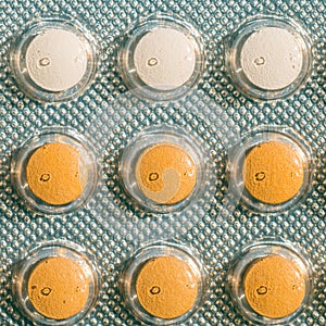 Contraceptive orange pills close up