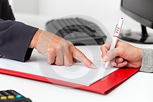Contract closing in a business office, signature on a empty document
