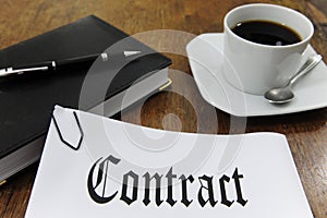 Contract and coffee on a desk