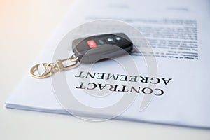 Contract document with car and remote key. buy and sale, insurance, rental and contract agreement concepts
