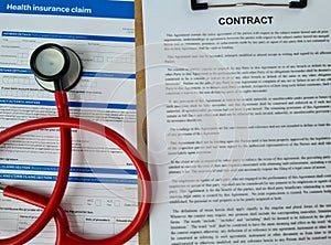 Contract for health insurance payout with stethoscope