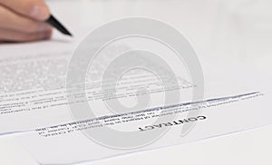 Contract signing concept. Businessman hand with pen over document closeup