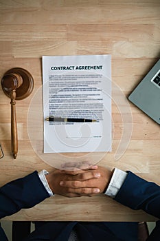 contract was placed on table inside legal counsel office, ready for investors to sign the contract to hire a team of lawyers to