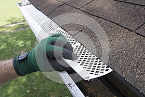 Contractor Adjusting Plastic Gutter Guards