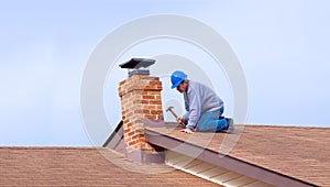 Contractor Builder with blue hardhat repairing roof