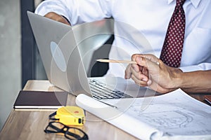 Contractor construction engineer meeting talking together on architect table at construction office site. Businessman engineer