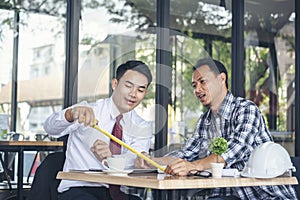 Contractor construction engineer meeting together on architect table at construction site. Business man and engineer manager