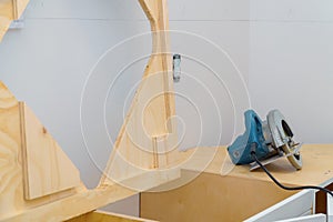 Contractor cutting laminate kitchen formica counter top. Focus on saw