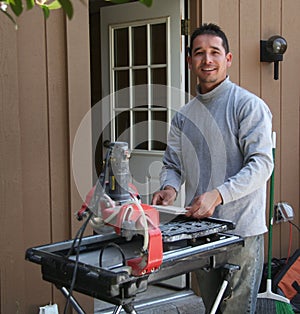 Contractor cutting tiles