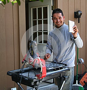 Contractor cutting tiles