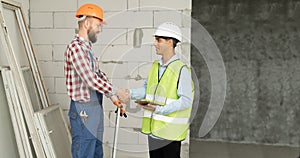 Contractor and engineer shaking hands to agree to build a house or building. construction worker accepts job wage terms