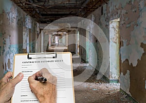 Contractor filling out estimate for abandoned office or hotel