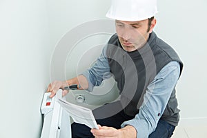 Contractor following instructions to install and set up electric radiator