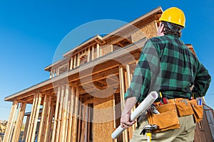 Contractor In Front New House Wood Framing at Construction Site