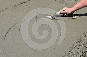 Contractor hand finishing concrete floor