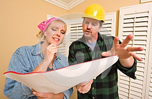 Contractor in Hard Hat Discussing Plans with Woman