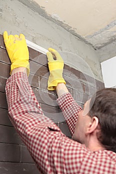 Contractor installing tiles