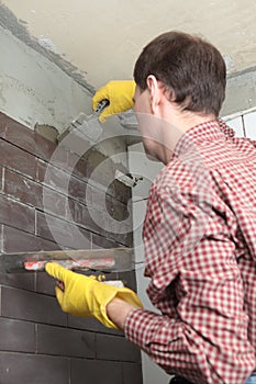 Contractor installing tiles